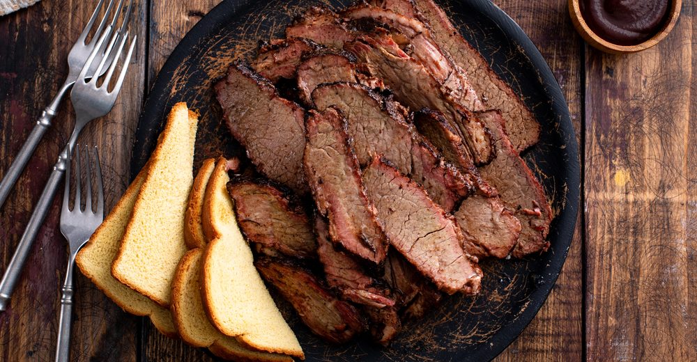 Smoked brisket plated with toast and barbecue sauce